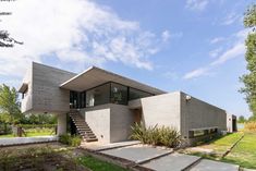 a concrete house with steps leading up to it