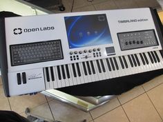 an electronic keyboard sitting on top of a tiled floor