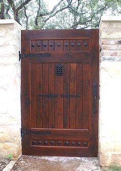 an open wooden door in front of a stone wall