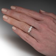 a woman's hand with a diamond ring on it