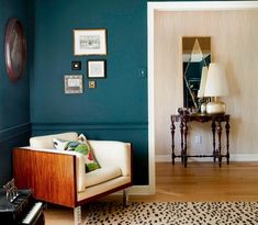 a living room with blue walls and leopard print rug