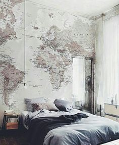 a bedroom with a map on the wall