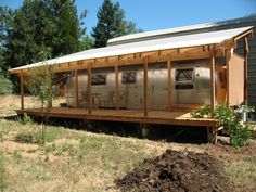 a train car sitting on top of a wooden platform in the middle of a field