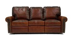 a brown leather couch sitting on top of a white floor