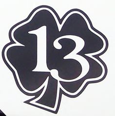 the number thirteen sticker is black and white with a flower on it's side