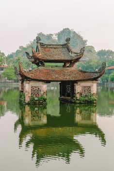 an old building sitting on top of a lake