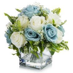 a vase filled with white and blue flowers