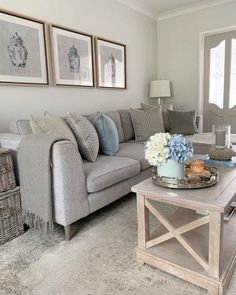 a living room filled with furniture and pictures on the wall above it's coffee table