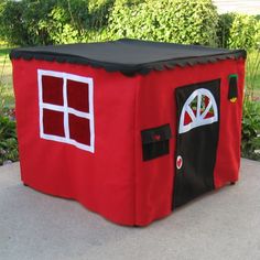 a little red house made out of felt with windows and doors on the front door