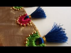 two pieces of fabric with tassels on them