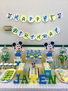 a mickey mouse birthday party with cake and decorations