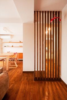 a living room filled with furniture and wooden slats