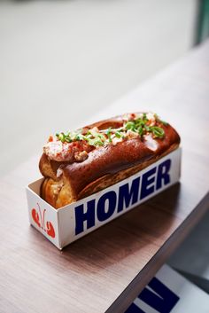 a box that has some kind of food inside of it on a wooden counter top