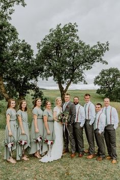 a group of people standing next to each other on top of a grass covered field