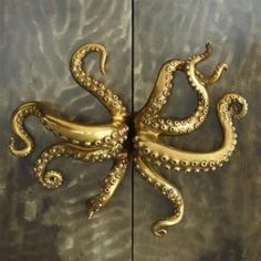 an octopus is on the wall with gold paint