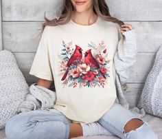 This gorgeous T-shirt features a couple of beautiful Red Cardinals among florals and will be a wonderful addition to your wardrobe or will make a great gift for anyone who loves nature and birds! Comfort Colors garment-dyed t-shirt is a customizable tee made 100% with ring-spun cotton. The soft-washed, garment-dyed fabric brings extra coziness to your wardrobe while the relaxed fit makes it an excellent daily choice. The double-needle stitching throughout the tee makes it highly durable while th Casual Red T-shirt With Floral Embroidery, Red Cotton T-shirt With Floral Embroidery, Spring Cottagecore Printed T-shirt, Summer Crew Neck T-shirt With Bird Print, Womens Bird Shirt, Red Cardinal, Vintage Birds, Cardinals, Dye T Shirt