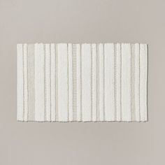 a white rug with vertical stripes on it