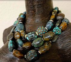 This multiple strand Hubei Turquoise boulder statement necklace has all the wow factor you have come to expect from Kat Kouture! This bold, chunky and heavy piece is actually a unisex design so men are welcome to it, also! Three strands of Hubei turquoise are space with either gold tone metal daisies or rhinestone rondelles. There is one inlaid turquoise brass bead from Tibet which serves as an accent and adds additional interest and drama. This piece adjusts from 17-20" and closes with an XL fa Luxury Ceremonial Jewelry With Large Beads, Artisan Turquoise Stone Necklace, Artisan Turquoise Necklace, Egg Baked, Gaudy Jewelry, Rocker Chic Accessories, Chunky Turquoise Necklace, Hubei Turquoise, Exotic Jewelry