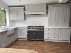 a kitchen with white cabinets and an oven