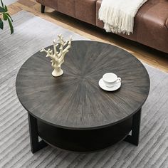 a coffee table sitting on top of a rug next to a couch