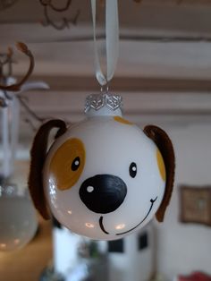 a glass ornament with a dog's face hanging from the ceiling in a living room