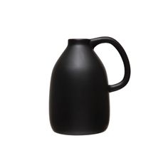 a black jug sitting on top of a white surface