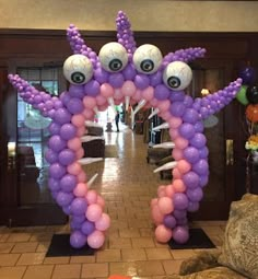 an inflatable balloon octopus with eyeballs on it's head and legs