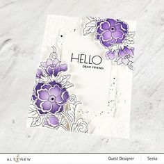 a card with purple flowers on it and the words hello written in black ink next to it