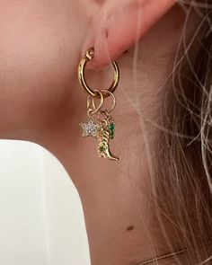 Add some western charm to your accessory collection with our Ernest Charm Hoop Earrings! These hoops feature playful cowboy boot and star charms set with sparkling crystals and emerald accents. Perfect for making a statement with a touch of playful sass. Yeehaw! Item Details: Length: Approx 1/2" 18k Gold plated Waterproof Hoops Gold Plated Brass Charms (not waterproof) Hypoallergenic Use a jewelry cloth to clean everyday oils off Avoid contact with chemicals such as hairspray, lotions, perfumes, Star Hoop Earring, Hoops Gold, Brass Charms, Cowboy Boot, Charm Set, Sparkling Crystal, Star Charms, Cowboy Boots, Gold Earrings