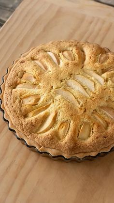 an apple pie sitting on top of a wooden table