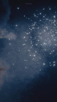 fireworks are lit up in the night sky with stars and clouds around them as if to celebrate