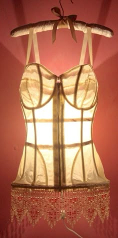 a light that is on top of a lamp in the shape of a corset