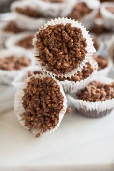 several chocolate cupcakes are sitting on a table