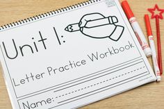 a letter practice workbook with pencils and crayons next to it on a table