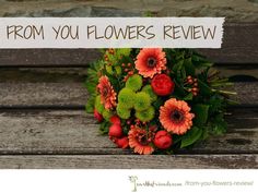 a bouquet of flowers sitting on top of a wooden bench