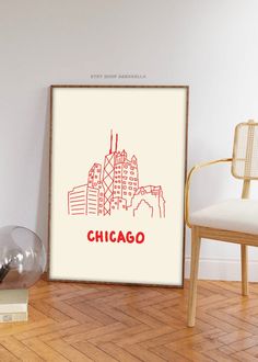 the chicago skyline is drawn in red on a white background, framed in a wooden frame