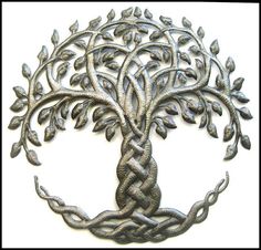 the tree of life is depicted in this metal wall art piece, which features leaves and branches