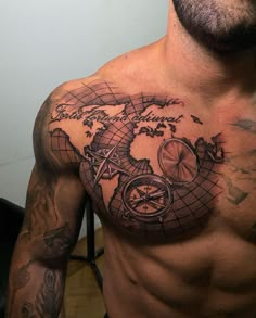 a man with a tattoo on his chest has a world map and a compass in the middle