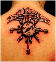 the back of a woman's neck with a clock and compass tattoo on it