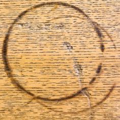 a circle drawn in the middle of a wooden surface