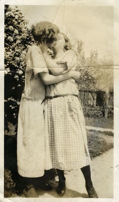 an old photo of two women hugging each other