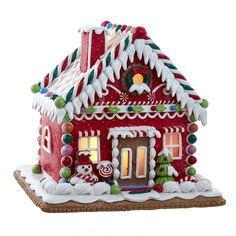 a red and white gingerbread house with candy decorations