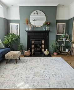 a living room filled with furniture and a rug on top of a hard wood floor