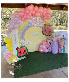 the table is set up with balloons and decorations for a children's birthday party