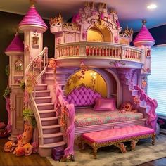 a pink princess castle bed with stairs to the second floor and lots of stuffed animals around it