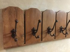 four coat hooks are mounted on the wall