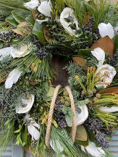 a wreath with white flowers and greenery