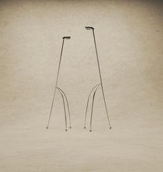 two metal poles standing next to each other on top of a white floor covered in dirt