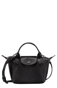 This scaled-down leather version of Longchamp's Le Pliage boasts the same foldaway design that made the bag a worldwide cult favorite. Top carry handles and a removable crossbody strap add to its ingenious versatility. Structured silhouette with flat base for stability Logo-jacquard lining Leather Imported Longchamp Pouch, Woman Bags Handbags, Black Leather Handbags, Handle Bag, Longchamp Le Pliage, Leather Handbag, Leather Top, Leather Crossbody Bag, Cowhide Leather