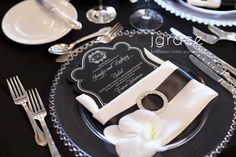 a black and white table setting with silverware